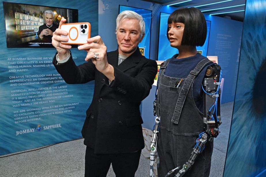 Baz Luhrmann taking a selfie with Ai-Da robot