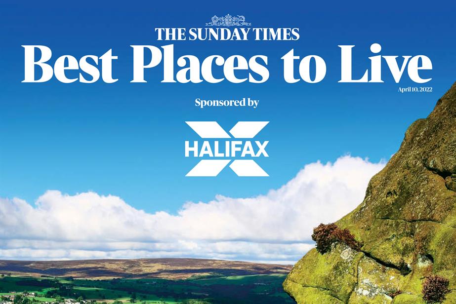 A landscape showing a rocky hill next to sweeping fields and a blue sky showing the words: "The Sunday Times Best Places to Live Sponsored by Halifax"